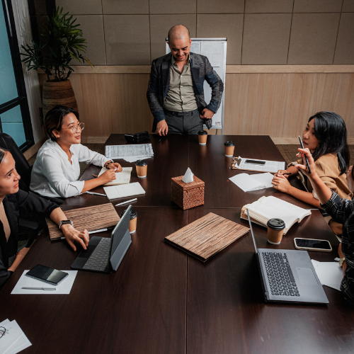 Diverse team of professionals collaborating around a conference table in a modern office setting